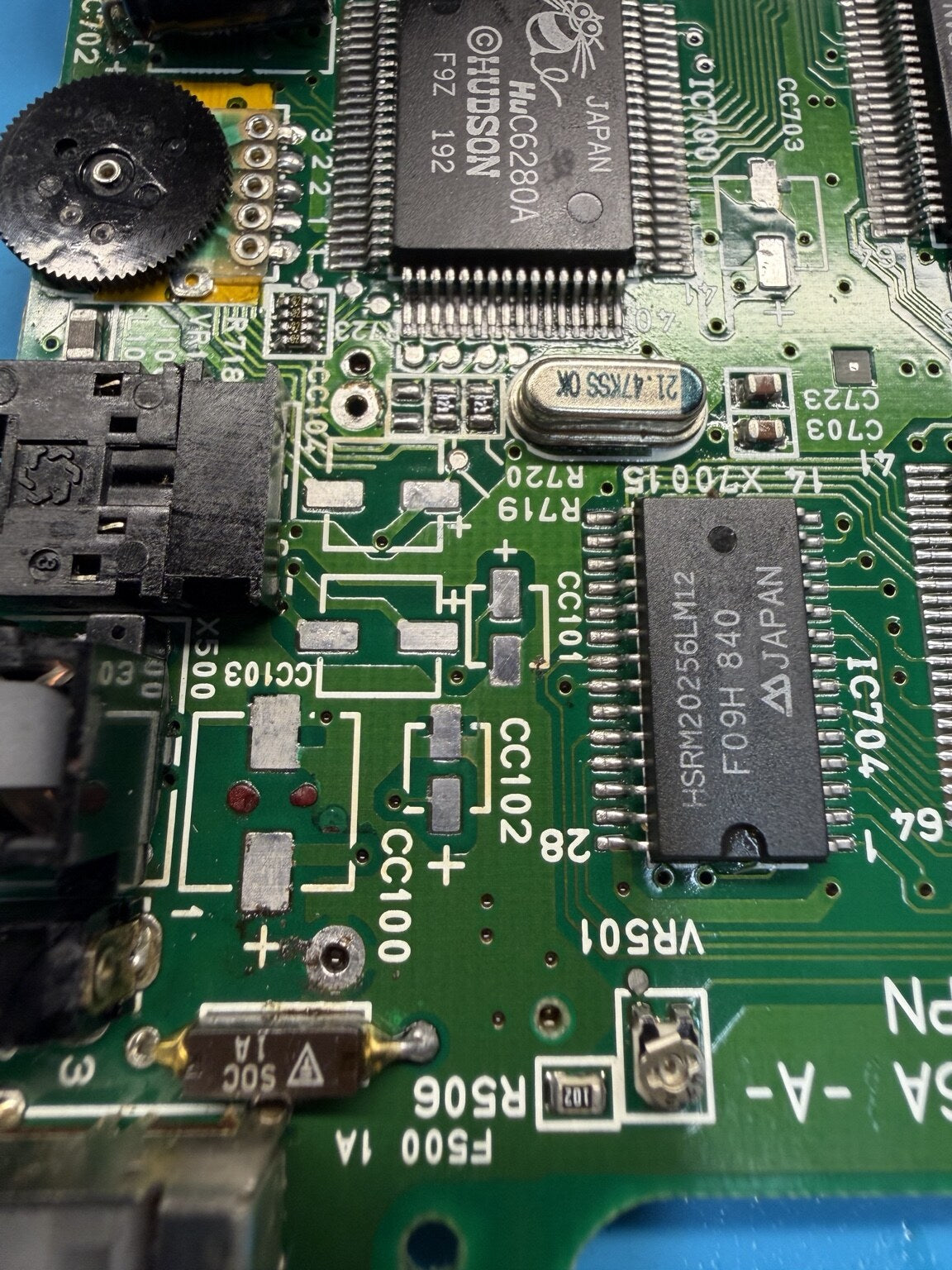Close-up of PC Engine GT capacitor pads cleaned after removal of old capacitors
